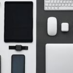 Stylish flatlay of modern tech gadgets including tablet, smartphone, smartwatch, and accessories.